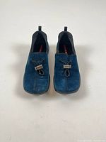 Front view of blue suede PRADA slip-on shoes