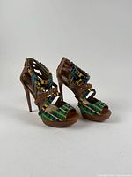 Pair of brown leather stiletto sandals with bead, chain and embroidery detailing, side angle