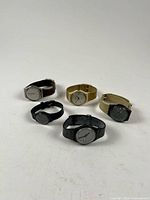 Group view of all five Swatch wristwatches showing case and strap colour variety