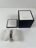 Watch, presentation box closed and service booklet on white background