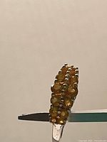 Side view of ring showing pave amber crystals and silver band