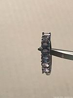 Side profile showing row of amethyst stones on silver band