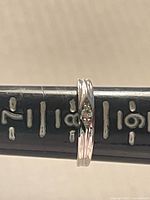 Side view of sterling silver ring on mandrel showing crystal and double-groove shank