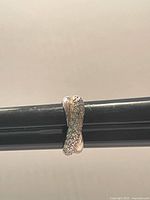 Ring showing crystal-covered crossover design