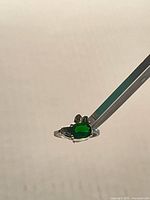 Front view of sterling silver ring with green stone