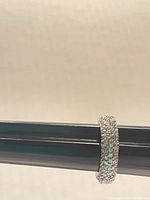 Side view of sterling silver pave crystal band on mandrel