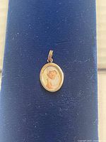 front view of oval sterling silver pendant with portrait