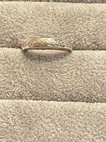 Silver band ring on display pad