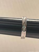 Side view of sterling silver band ring showing crystal centre