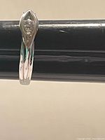 Ring side view showing band and marquise crystal setting