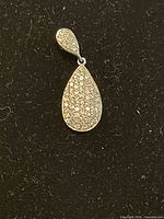 Front view of teardrop sterling silver charm showing pavé crystals