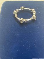 Sterling silver ring top view on blue pad