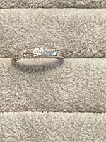 Ring front showing central stone and accent stones