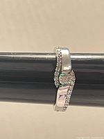 Side view of sterling silver ring on mandrel showing crystal setting and pave shoulders