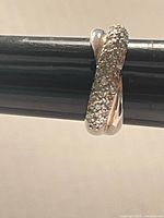 Ring side profile showing crystal-covered section and plain silver side