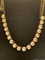 Full view of necklace showing arrangement of rhinestone settings and chain