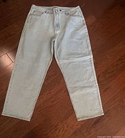 Full view of light wash jeans laid flat