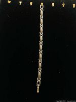 Full view of silvertone link bracelet showing design and clasp