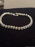 Full view of bracelet showing silvertone setting and clear stones