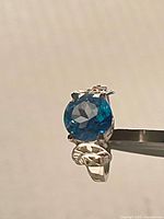 Front view of ring showing blue topaz and setting
