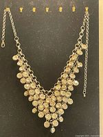 Full view of rhinestone bib necklace hanging to show overall design and adjustable chain