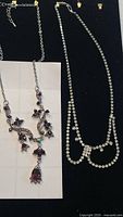 Both rhinestone necklaces laid flat for full view