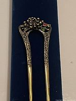 Full view of two-prong hair pin on backing