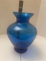 Side view of the blue glass decorative centerpiece showing its shape and color.