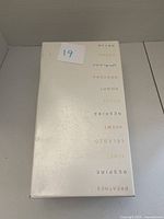 Closed beige box with brand and inspirational words printed on the lid.