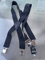 Full view of black Kodiak suspenders with metal clips and central leather patch
