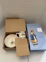 Photo of Wedgwood children's plate and mug set inside original box with protective cardboard insert.