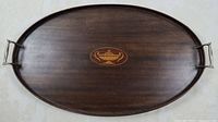 Top view of oval mahogany tray with metal handles