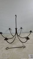 Full view of metal chandelier showing six arms and top hook