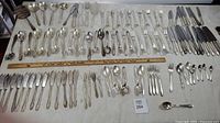 Overall view of all flatware laid out showing quantity and variety