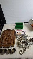 overview of carving board, bowls, cookie press box, cutters, green rack