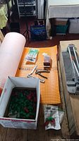 Group shot showing Schluter DITRA roll, tile cutter, box of clips, spacers, tools