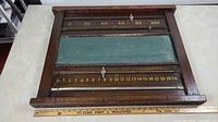 Front view of wooden billiards scoreboard showing entire frame and chalkboard