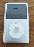 Front view of Apple iPod showing screen and click-wheel, visible mark on screen