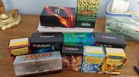 Multiple Magic and Dragon Shield boxes filled with cards