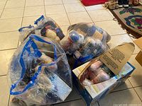 Three large bags and two boxes filled with assorted yarn skeins