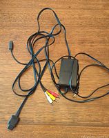 Full view of power adapter and AV cable laid out