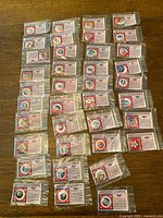 Full group of reproduction buttons laid out in grid, each in individual sleeve