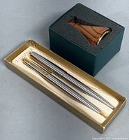 Two Parker pens, a ballpoint pen and a mechanical pencil, in original Parker box, showing metal bodies with some minor wear.