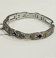 Close-up image showing the bracelet curved with detailed view of stones and clasp.