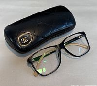 Chanel eyeglasses with original quilted black case displayed closed