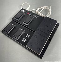 Front angled view of the black Line 6 FBV Express MK II USB control pedal showing multiple labeled footswitches and the expression pedal with rubber grip.