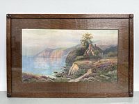 Front view of framed signed EYL seascape art print with coastal scene and cottage near water.