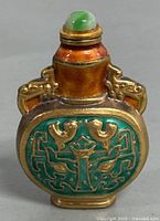 Front and side view of the 3-inch Asian hand decorated brass perfume/snuff bottle with green enamel and gold details featuring bird motifs.
