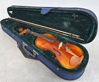 Full violin with bow inside blue hard case lined with green velvet fabric.