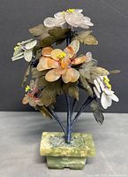 Front view of bonsai tree sculpture showing quartz flowers in white, pink, and orange with yellow stamen, green jade leaves, and jade base.